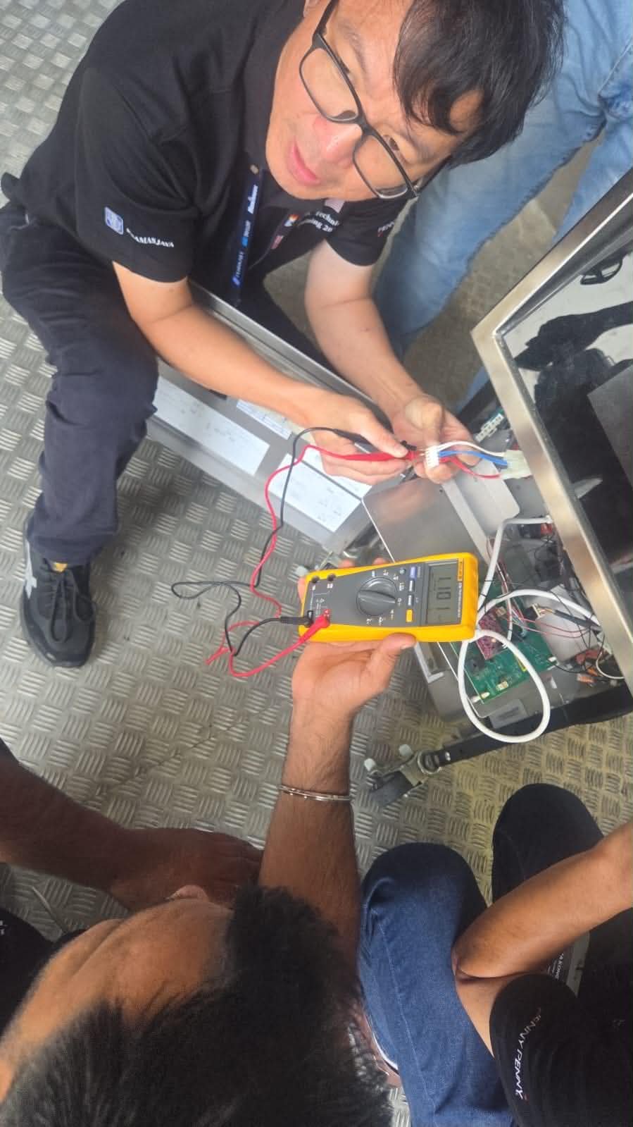 Technician using a meter for equipment diagnostics